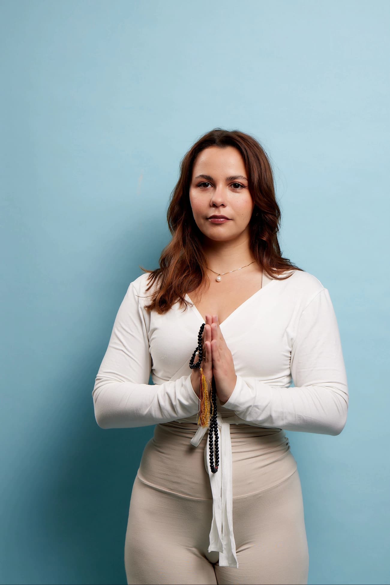 Studio portrait of Boyana Vancheva standing in anjali mudra holding a mala