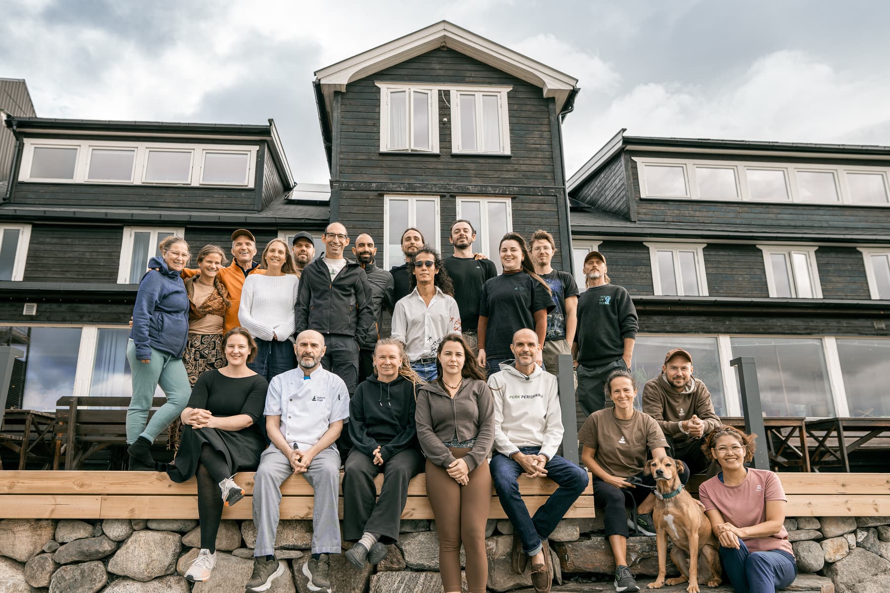 The team of Nosen Yoga Fjellhotell gathered on the terrace of the timber lodge in the Norwegian mountains